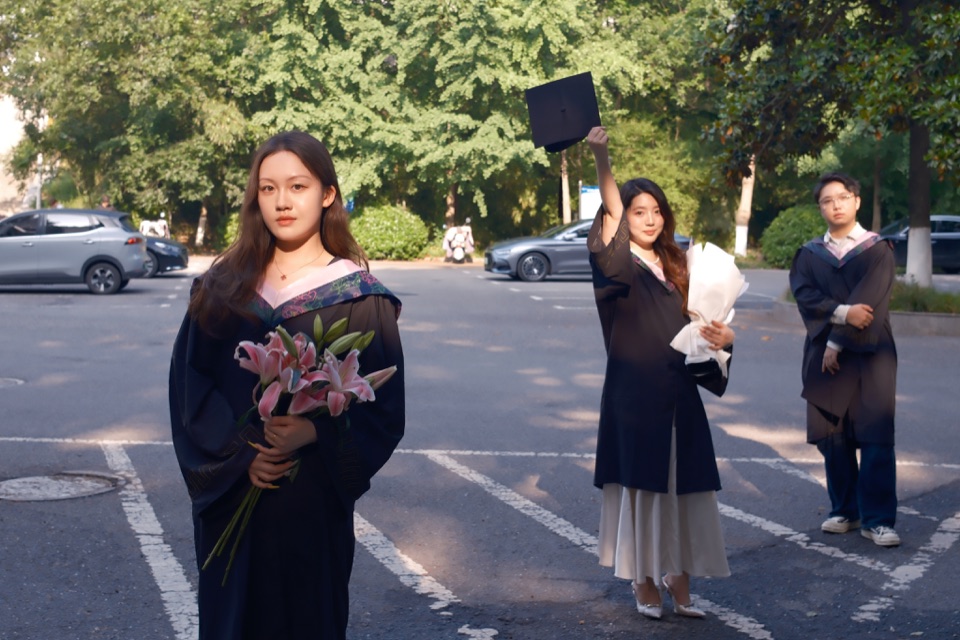 Graduates in a green garden at the end of the day